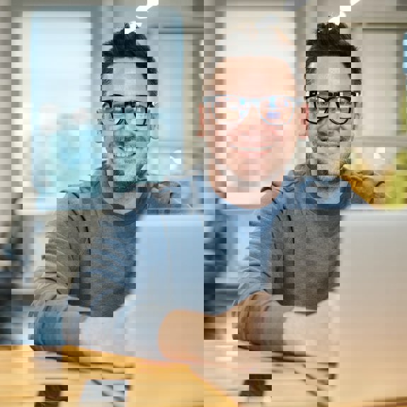 Man with computer smiling
