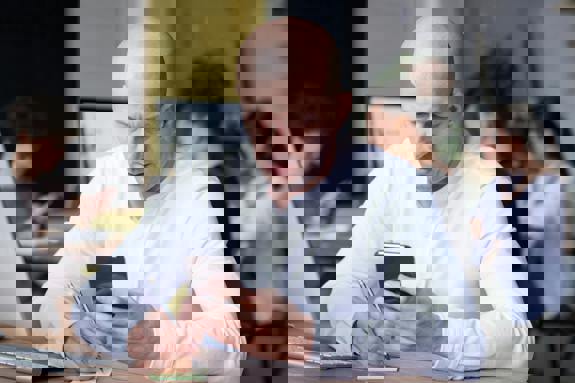 picture of man at desk on phone