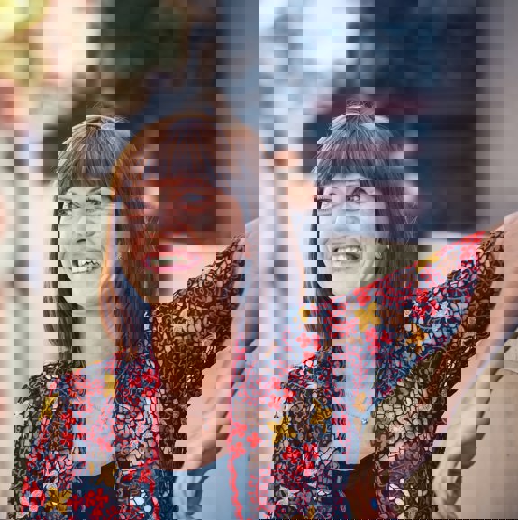 Woman smiling with red top